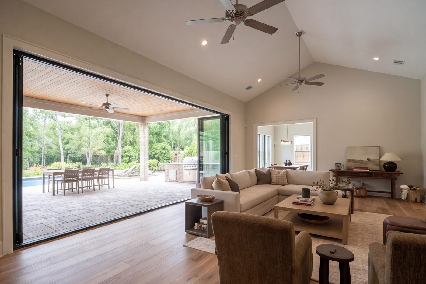 wide family room with a wall of folding glass doors open to the patio